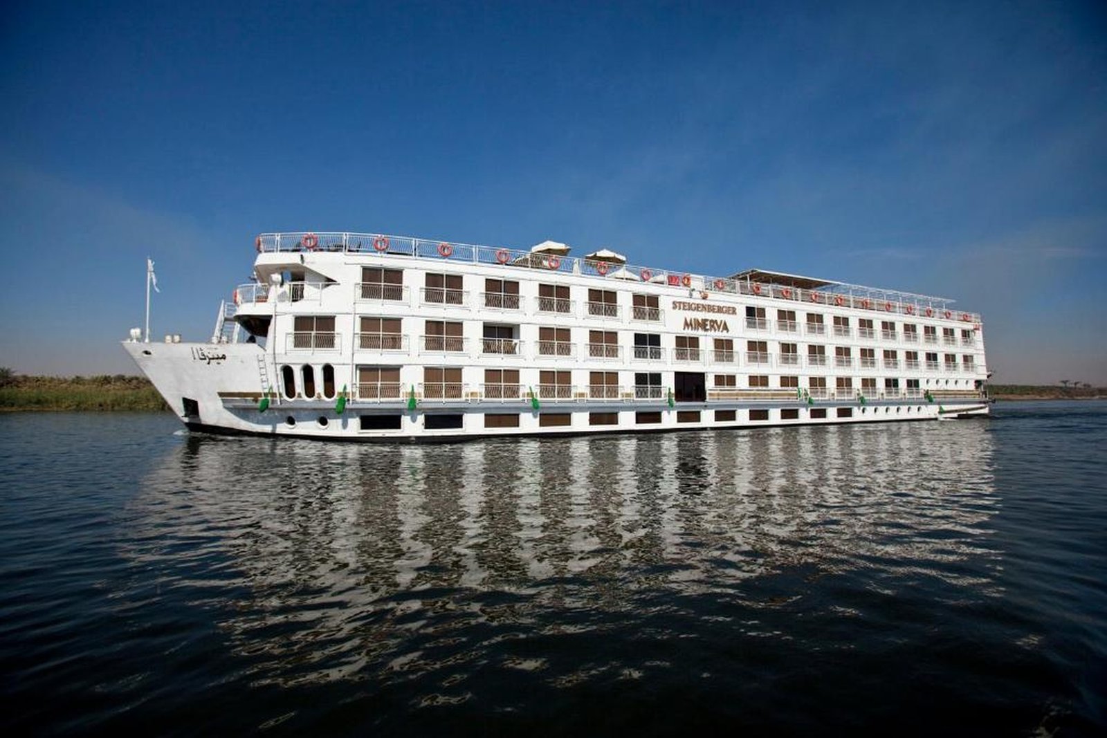 Luxury Steigenberger Minerva Nile Cruise sailing on the Nile River with elegant cabins, fine dining restaurant, swimming pool, and premium lounge areas.